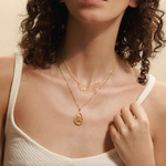 Model wearing the Intention of New Beginnings Necklace Set, showcasing the layered lotus pendant and leaf necklace, highlighting their significance as spiritual jewelry for yoga and meaningful intentions.