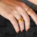 A close-up of the Taryn Truly Protect Your Peace Spinner Ring being worn on a hand, showcasing its unique design. This spiritual jewelry piece embodies protection and inner serenity, perfect for meditation and meaningful moments. Ideal for yoga enthusiasts and those interested in talismans and manifestation.
