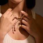 A person adorned with the Infinite Possibilities Moonstone Celestial Charm necklace, featuring moon and sun charms that embody spirituality. This stunning piece of jewelry serves as a meaningful representation of zodiac energies, meditation, and manifestation, perfect for those seeking protection and spiritual growth.