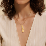 Model displaying the Story of Gemini Zodiac Necklace against a soft background, illustrating the bond between spirituality and personal meaning through this elegant talisman.