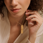 A model wearing the Story of Leo Zodiac Necklace, showcasing its elegant design against a simple outfit, embodying the spirit of spiritual jewelry. This beautiful piece signifies protection and the essence of the sun and moon, making it a meaningful accessory for yoga and meditation practices.