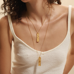 A model showcasing the Story of Pisces Zodiac Necklace, elegantly layered with a second zodiac pendant. This spiritual jewelry embodies the charm and meaning of Pisces, perfect for yoga and meditation enthusiasts seeking to manifest their dreams.