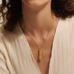 Close-up of the Story of Pisces Zodiac Necklace worn elegantly by a model. The intricate design highlights the zodiac symbol and the illuminating white topaz, making this spiritual jewelry a meaningful talisman for those aligned with the Pisces sign.