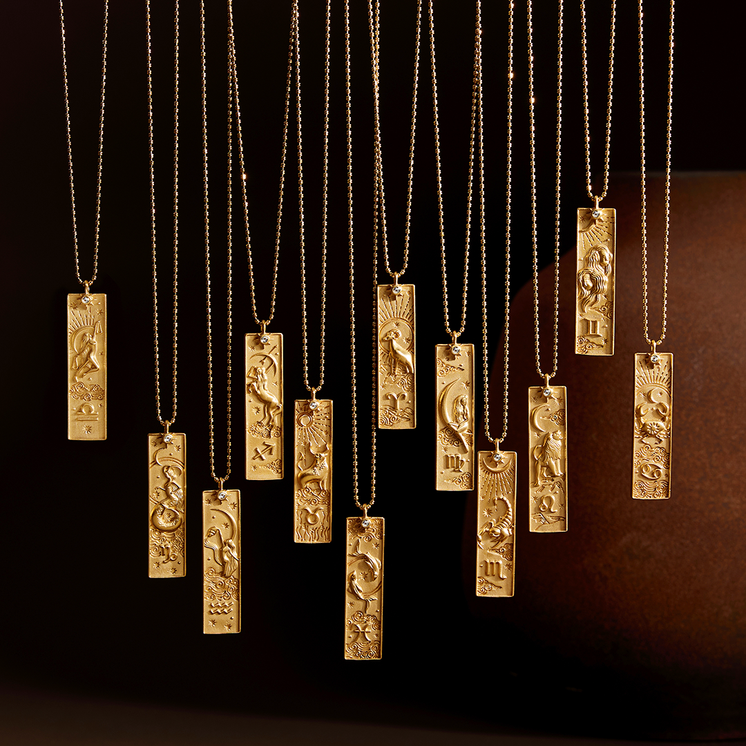 Display of various Aquarius Zodiac Necklaces illuminated in soft light, emphasizing their unique designs. This collection of spiritual jewelry is perfect for those seeking deeper meaning and connection through zodiac signs, ideal for yoga practices and manifestation rituals.