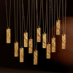 Display of various Aquarius Zodiac Necklaces illuminated in soft light, emphasizing their unique designs. This collection of spiritual jewelry is perfect for those seeking deeper meaning and connection through zodiac signs, ideal for yoga practices and manifestation rituals.