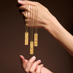 Hand holding multiple Story of Capricorn Zodiac Necklaces, highlighting the spiritual jewelry's design and zodiac connection. This collection serves as a meditation tool, a meaningful talisman for manifestation, embodying the essence of charm and protection.