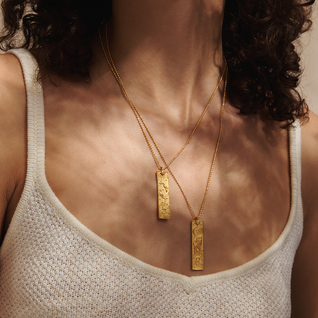 Close-up of multiple Story of Aquarius Zodiac Necklaces worn together, emphasizing their unique designs. This spiritual jewelry is ideal for those seeking meaningful talismans that resonate with the essence of Aquarius, perfect for enhancing meditation, manifestation, and personal growth.