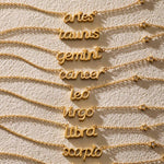 Variety of Zodiac Script Necklaces including 'virgo', each necklace showcases delicate gold lettering, making them meaningful spiritual jewelry. These talismans represent the zodiac signs and are great for meditation and manifestation, perfect for enhancing your yoga practice.