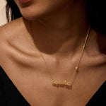A woman wearing the Aquarius Vision Zodiac Script Necklace, featuring a beautiful script design. This spiritual jewelry enhances the wearer’s meditation practice and serves as a zodiac-inspired talisman, promoting creativity and manifestation. A perfect piece for sun and moon enthusiasts who value meaningful spiritual accessories.