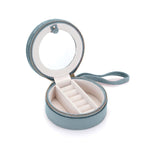 Inside view of the For the Journey Travel Jewelry Case featuring a round mirror, ring holder for 6 rings, and a soft velvet lining. Perfect for storing spiritual jewelry, meditation items, and talismans. Ideal for protecting your meaningful pieces during travel, including mala beads, zodiac-themed accessories, and more.