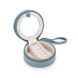 Inside view of the For the Journey Travel Jewelry Case featuring a round mirror, ring holder for 6 rings, and a soft velvet lining. Perfect for storing spiritual jewelry, meditation items, and talismans. Ideal for protecting your meaningful pieces during travel, including mala beads, zodiac-themed accessories, and more.
