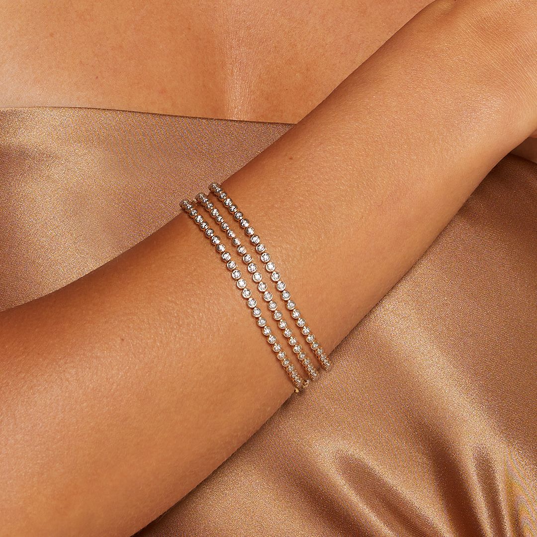 Elegant Diamond 14kt Gold Tennis Bracelet featured on a model's wrist, showcasing its brilliance and timeless design. This piece embodies the spirit of spiritual jewelry, perfect for meditation and manifestation. Ideal as a talisman or charm, it connects with the energies of the sun and moon, making it meaningful for yoga and zodiac enthusiasts.