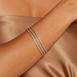 Elegant Diamond 14kt Gold Tennis Bracelet featured on a model's wrist, showcasing its brilliance and timeless design. This piece embodies the spirit of spiritual jewelry, perfect for meditation and manifestation. Ideal as a talisman or charm, it connects with the energies of the sun and moon, making it meaningful for yoga and zodiac enthusiasts.