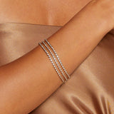 Elegant Diamond 14kt Gold Tennis Bracelet featured on a model's wrist, showcasing its brilliance and timeless design. This piece embodies the spirit of spiritual jewelry, perfect for meditation and manifestation. Ideal as a talisman or charm, it connects with the energies of the sun and moon, making it meaningful for yoga and zodiac enthusiasts.