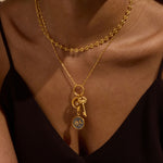 Close-up of layered necklaces featuring the Celestial Alignment Charm among other charms. This ensemble showcases spiritual jewelry that inspires intention, protection, and the rhythm of the cosmos.