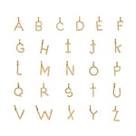 A display of Initial Letter Charms in 18kt gold plating, featuring the complete alphabet, perfect for personalized spiritual jewelry that embodies meaning and protection in meditation and yoga practices.