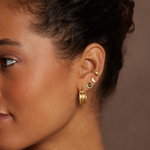 Model wearing multiple earrings including the Eternal Light Black Onyx Stud Earrings, showcasing stylish spiritual jewelry perfect for yoga and manifestation.