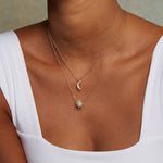 Model wearing the Moon Diamond 14kt Gold Pendant Necklace layered with other necklaces, showcasing a perfect combination of spiritual jewelry for a radiant look during meditation and yoga sessions, embodying the essence of the moon and its powerful charm.
