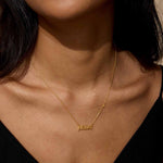 Model wearing the Pisces Intuition Zodiac Script Necklace, a stunning piece of spiritual jewelry that represents the zodiac sign Pisces. This talisman serves as a reminder for meaningful connections to the sun and moon, enhancing intuition and creativity.