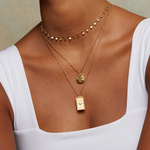 A model wearing the Sacred Realm Spinning Pendant Celestial Necklace layered with gold chains, embodying spiritual and zodiac themes, ideal for protection and meaningful manifestation.
