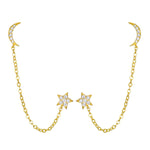 Pair of gold-tone earrings with crescent moon studs, dangling chain, and star charms set with crystals.