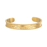 Breaking Dawn Sunrise Cuff bracelet showcasing an elegant etched sunrise design, perfect for spiritual jewelry and meditation. This 18kt gold plated cuff embodies the sun's energy, making it a meaningful talisman for yoga and manifestation.