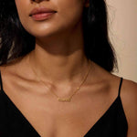 A model wearing the Taurus Stability Zodiac Script Necklace, showcasing its meaningful design as a spiritual talisman, ideal for yoga enthusiasts seeking zodiac-inspired protection.