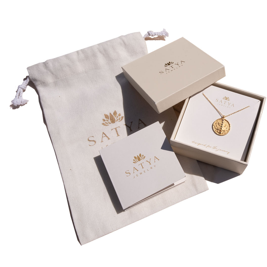 Elegant Gift Box containing spiritual jewelry from Satya, featuring a talisman pendant and a soft pouch, ideal for meditation and yoga practices, symbolizing protection and meaningful manifestation of one's zodiac qualities.