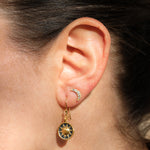 Close-up of a person wearing Ethereal Balance Earrings, showcasing the harmonious design of the sun and moon. This spiritual jewelry reflects a balance of vitality and nourishment, perfect for those practicing meditation and seeking meaningful talismans for protection and manifestation.