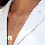 Aligned in Purpose Chakra Necklace showcased on a model, symbolizing spiritual jewelry perfect for meditation gifts, with elements promoting mantra, yoga, and meaningful living. The design is both symbolic and protective, embodying sacred values and manifestation themes, making it an ideal zodiac amulet.