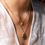 Close-up of the Pursue Your Truth Labradorite Necklace, featuring a stunning labradorite pendant set in 18k gold plate sun rays, perfect as spiritual jewelry and a meaningful meditation gift. Ideal for those seeking inspiration and symbolic protection in their yoga practice.