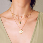 A layered look showcasing the Mandala Zodiac Taurus Emerald Necklace alongside complementary pieces. This configuration highlights its symbolic beauty, ideal for yoga practitioners seeking meaningful spiritual jewelry that embodies Taurus traits and enhances manifestation.