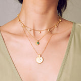 A layered look showcasing the Mandala Zodiac Taurus Emerald Necklace alongside complementary pieces. This configuration highlights its symbolic beauty, ideal for yoga practitioners seeking meaningful spiritual jewelry that embodies Taurus traits and enhances manifestation.