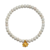 Walk in Harmony Lotus White Turquoise Gemstone Bracelet featuring smooth round white turquoise beads and a delicate golden lotus flower charm. This spiritual jewelry embodies the essence of meditation and protection, making it a meaningful talisman for yoga enthusiasts and those seeking harmony in their lives. Perfect for manifestation and as a zodiac charm, it serves as a reminder of new beginnings and infinite potential.