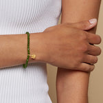 Close-up of Ganesha Hindu God, Guided Transformation Jade Gemstone Bracelet worn on a person's wrist, showcasing its spiritual significance and charm. This bracelet embodies spirituality, making it perfect for meditation, zodiac connections, and meaningful manifestations.