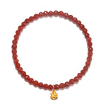 Ganesha Hindu God, Overcoming Obstacles Carnelian Gemstone Bracelet featuring a delicate golden Ganesha charm. This spiritual jewelry piece embodies confidence and strength, perfect for meditation and as a talisman for protection. Ideal for yoga practices and meaningful manifestations, this charm showcases the powerful connection between sun, moon, and the zodiac.