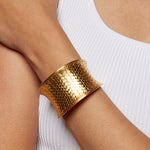 Gold Medium Basketweave Bracelet Cuff worn elegantly on a wrist, showcasing its intricate design. This spiritual jewelry piece is perfect for adding a meaningful touch to any outfit, embodying symbolism and manifestation.