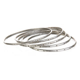 A collection of Silver Etched Bracelets Bangles titled Melody, showcasing various hand-stamped designs, perfect for spiritual jewelry and meditation gifts, embodying symbolic meaning and manifestation energy for yoga enthusiasts.