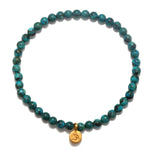 Protective Om Turquoise Gemstone Bracelet featuring turquoise beads and a gold Om symbol, perfect for spiritual jewelry and meditation, serving as a talisman for protection and manifestation. Ideal for yoga enthusiasts and those seeking meaningful accessories that connect with the sun and moon energies.