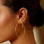 Close-up of the Stand By Your Side Ear Cuff worn with various gold earrings, reflecting a beautifully layered look in spiritual jewelry. This piece captures the essence of protection and meaning for yoga and meditation.
