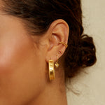 Model wearing the Stand By Your Side Ear Cuff alongside other earrings, showcasing how it complements spiritual jewelry styles. This piece is ideal for showcasing personal style while embracing meditation and manifestation meanings.