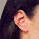 Model highlighting the Stand By Your Side Ear Cuff, emphasizing its unique design in gold plate. This spiritual jewelry piece enhances your aura with meaning while connecting to meditation and zodiac elements.