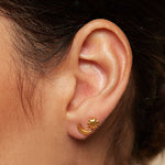 Close-up of the Celestial Light Moon and Sun Stud Earrings worn on an ear, symbolizing vitality and nourishment; ideal for yoga practices and spiritual journeys, reflecting the essence of meaningful talismans.