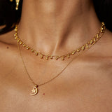 Close-up of the Joyful Choker Necklace alongside other necklaces, showcasing its elegant design and shine. This piece is a beautiful representation of spiritual jewelry, ideal for meditation and enhancing one's connection to the sun and moon.