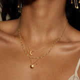 Elegant display of the Cast a Light, Sun, Moon & Citrine Triple Necklace highlighting its layers and gemstones. This spiritual and meaningful charm serves as a protective amulet while enhancing your yoga practice and meditation routine.
