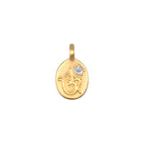 Sacred Sounds Om White Topaz Charm featuring a beautifully engraved Om symbol in 18kt gold plate, enhanced with a white topaz stone, perfect for spiritual jewelry, meditation, and as a meaningful charm for protection and manifestation.