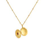 Open view of the Lotus Garnet Birthstone Locket Necklace - January, highlighting its intricate engraving and the potential to hold meaningful mementos, serving as a talisman for protection and zodiac energy.