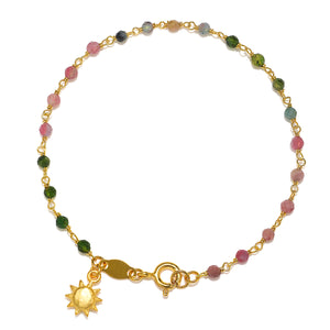 Abundant Joy Tourmaline Gemstone Bracelet featuring vibrant tourmaline stones and a gold sun pendant, designed for spiritual jewelry, meditation, and protection by Satya Jewelry. This meaningful piece symbolizes vitality and leadership, ideal for yoga and manifestation.
