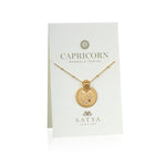 Mandala Zodiac Capricorn Red Garnet Necklace displayed on a beautiful presentation card by Satya Jewelry. This sacred amulet combines the essence of Capricorn with a touch of hamsa symbolism, ideal for spiritual jewelry and meditation gifts.