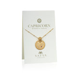 Mandala Zodiac Capricorn Red Garnet Necklace displayed on a beautiful presentation card by Satya Jewelry. This sacred amulet combines the essence of Capricorn with a touch of hamsa symbolism, ideal for spiritual jewelry and meditation gifts.